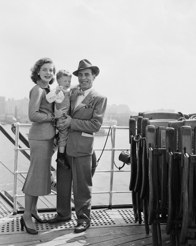 Humphrey Bogart, his actress wife, Lauren Bacall, and their son, Stephen, aged two, gather on a deck of the French liner Ile De France on Sept. 13, 1951 in New York City, following their arrival from Europe.