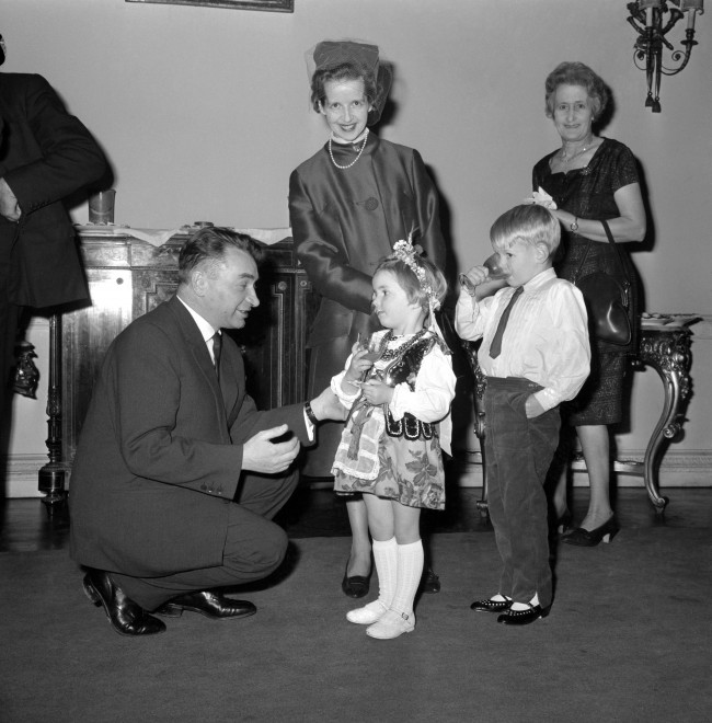 Sue Ryder and her two children Elizabeth and Jeromy, at the Polish Embassy in Portland Place, London, where she was presented the Order of Polonia Restituta Officer's Cross, awarded by the Council of State of the Polish People's Republic. Polish Ambassador Jerzy Morawski is seen talking to Elizabeth, who is in traditional Polish costume. Ref #: PA.9342336  Date: 25/11/1965 