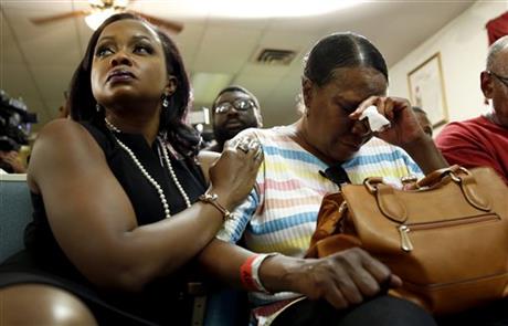 Phaedra Parks, left, comforts Desuirea Harris, the grandmother of Michael Brown, during a news conference Monday, Aug. 11, 2014, in Jennings, Mo. Michael Brown, 18, was shot and killed in a confrontation with police in the St. Louis suburb of Ferguson, Mo, on Saturday, Aug. 9, 2014.(AP Photo/Jeff Roberson)