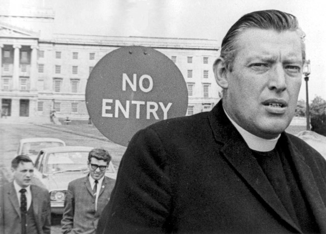  In this Aug. 23, 1969 file photo Northern Ireland's Democratic Unionist Party (DUP) leader Ian Paisley leaves Stormont Castle in Belfast, Northern Ireland, after handing in a petition. Paisley the fiery Protestant leader has died in Northern Ireland aged 88 his wife Eileen said Friday Sept. 12, 2014. Much like the Ulster weather, Ian Paisley could offer beaming sunshine one minute, stinging hailstones the next. The international image of Paisley _ that of Northern Ireland's most dangerous demagogue, a belligerent bigot committed to keeping Irish Catholics at bay and out of power _ was well-documented in its own right. But understanding the worst of the public Paisley wouldn't prepare you for meeting him in the flesh. (AP Photo/Peter Kemp, File)