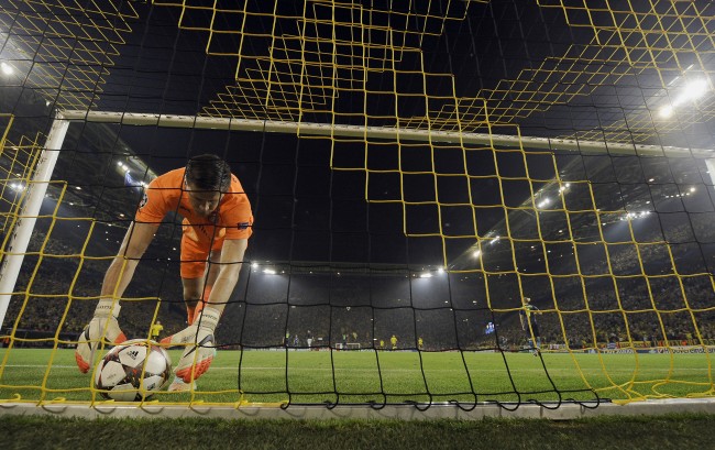 Arsenal's goalkeeper Wojciech Szczesny lifts the ball after Dortmund's Ciro Immobile, scored his side's opening goal during the Champions League group D soccer match between Borussia Dortmund and Arsenal in Dortmund, Germany, Tuesday, Sept.16, 2014. (AP Photo/Martin Meissner)