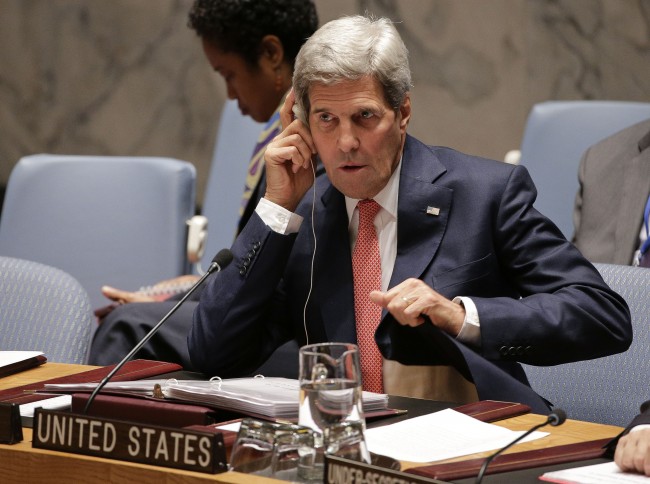 U.S. Secretary of State John Kerry, adjusts his translation ear piece during a U.N. Security Council meeting, Friday, Sept. 19, 2014, at the United Nations headquarters. The Security Council met Friday to discuss the situation of the Islamic State group in Iraq. (AP Photo/Julie Jacobson)