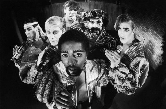 The Village People, a rock band previously known for their outlandish costumes as well as their music, demonstrate their current "new look" at New York's Underground club, June 29, 1981. At center, foreground is lead singer Ray Simpson. Others are, from left, Felipe Rose, David Hodo, Alex Riley, Glenn M. Hughes, and Jeff Olson. (AP Photo/Richard Drew)