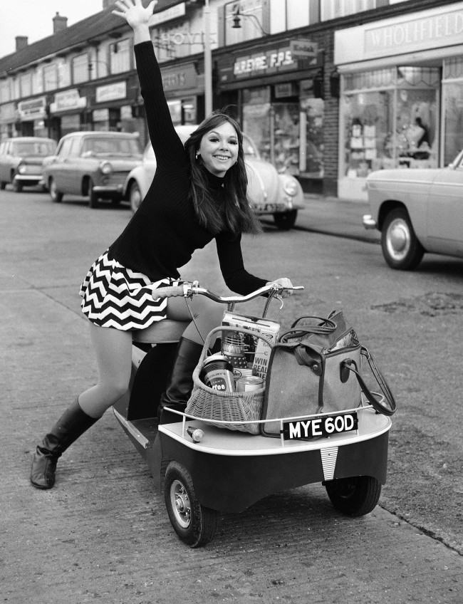 American dancer Felicity 'Flick' Colby with a new battery-powered mini-shopper, in Sidcup, Kent, on Dec. 15, 1966. (AP Photo) Ref #: PA.10871986  Date: 15/12/1966