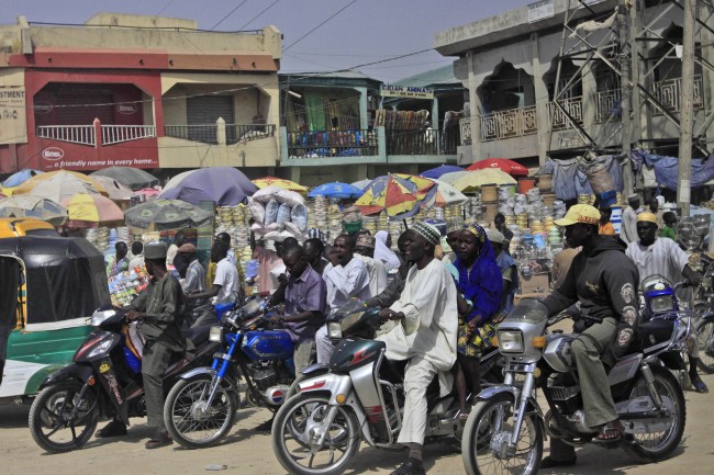 otorcycle taxis wait for traffic near a market in Kano, Nigeria, Monday, Jan. 23, 2012, following recent sectarian attacks. The emir of Kano and the state's top politician offered prayers Monday for the more than 150 people who were killed in a coordinated series of attacks on Friday by the radical Islamist sect called Boko Haram which means "Western education is sacrilege" in the Hausa language of Nigeria's north.(AP Photo/Sunday Alamba)