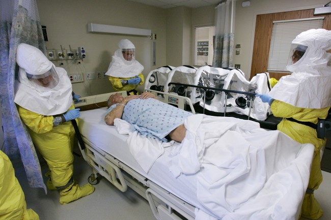  In this file photo from Oct. 28, 2006, a mock patient is cared for during a drill at the Nebraska biocontainment unit in the Nebraska Medical Center in Omaha, Neb. A missionary, Dr. Rick Sacra, 51, who was infected with Ebola while serving in Liberia is being flown to the Nebraska Medical Center in Omaha where he is expected to arrive Friday morning. Sacra will begin treatment in the hospital's special isolation unit, believed to be the largest in the U.S. (AP Photo/Nati Harnik)