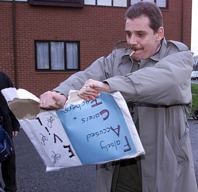 Steven Messham in Mold, North Wales, a victim of abuse whilst in care rips up a protest banner which was part of a small demonstration against the damning report into two decades of sexual and physical abuse of youngsters in North Wales children's homes. * Social workers, care home staff, local authorities, police and the Welsh Office were severely criticised by the report, entitled 'Lost in Care', into the UK s biggest child sex scandal. Ref #: PA.1270168  Date: 15/02/2000