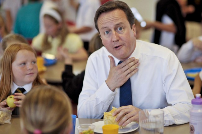 Prime Minister David Cameron jokes with school children as he eats a sandwich during lunch with the pupils at Newquay Junior school. Picture date: Friday July, 9, 2010. See PA story POLITICS Cameron. Photo credit should read: Ben Birchall/PA Wire Ref #: PA.9155857  Date: 09/07/2010