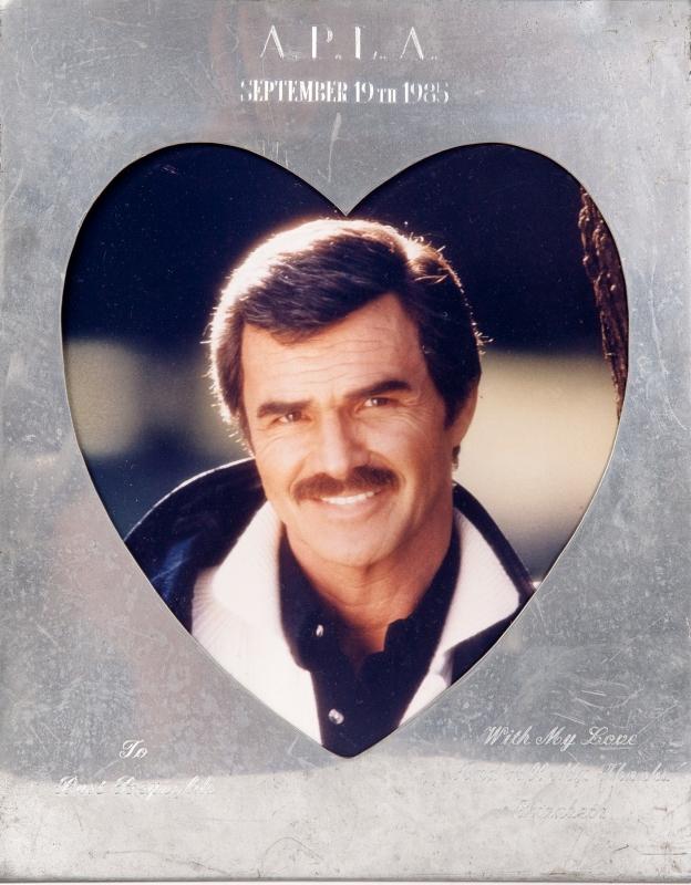 Estimate: $400 - $600 Starting: $200 A frame with an inscription to Burt Reynolds from Elizabeth Taylor. The silver frame has a heart-shaped window with an image of Reynolds and is inscribed "A.P.L.A. September 19th 1985 To Burt Reynolds With My Love And All My Thanks Elizabeth."