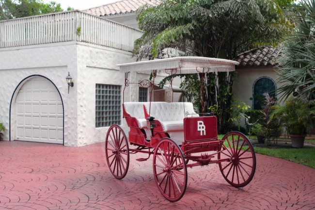  Starting: $1,500 A custom-built Valley Carriage Works red and white covered carriage with the Burt Reynolds Ranch "BR" monogram. This carriage was a gift to Burt Reynolds from Dolly Parton.