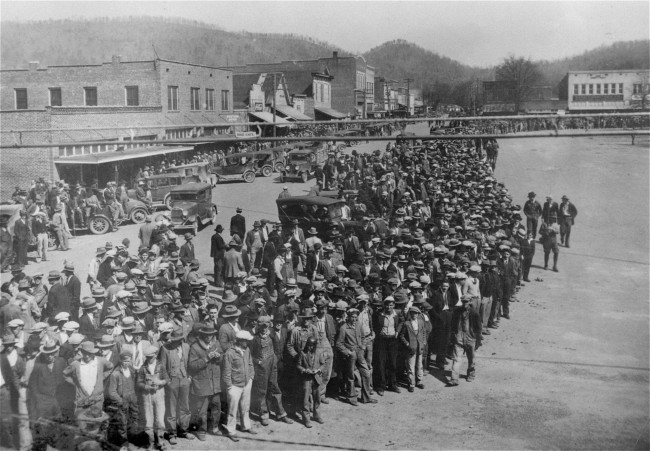 Here is shown a part of the crowd of 10,000 persons who jammed the courthouse square in the little town of Scottsboro, Alabama, April 6, 1933, on the opening of the trials of nine black youths accused of attacking two white girls near Sevenson, Ala., March 24, 1931. National Guardsmen with fixed bayonets patrolled the courthouse grounds, and women and minors were barred from the courtroom. The state asked for the death penalty for the first two defendants to be placed on trial. The other seven will be tried later. The nine were identified by the two girls as the ones who boarded the freight car in which they and seven white youths were riding, forced five of the white youths from the train, knocked the other two unconscious and attacked the girls.