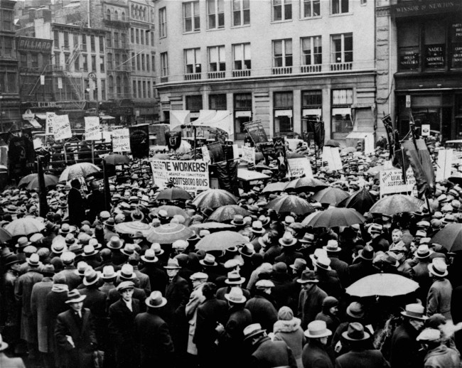 More than 1,200 braved disagreeable weather to attend a rally in Union Square, New York City, December 9, 1933, on behalf of the nine Scottsboro boys. The meeting was arranged by the International Labor Defense and was backed by the Communist Party. The marchers carried banners and a sign with the image of a lynching, and the legend "Alabama - The land of the tree and the home of the grave."