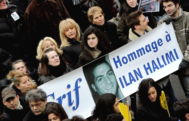 Tens of thousands of demonstrators, including ministers and politicians of all stripes, march through Paris, the French capital, to show their opposition to racism and anti-Semitism after the brutal killing of Ilan Halimi, a Parisian Jew, Sunday, Feb. 26, 2006. The Halimi case has revived fears that anti-Semitism remains in French society. The banner reads 'Tribute to Ilan Halimi'. (AP Photo/Jacques Brinon)