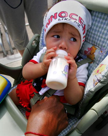 Michael Jackson fan, Bianca Martinez, eight-months-old, drinks from her baby bottle as she wears a hat with the message 'Innocent Like Me' while sitting in her stroller outside the Santa Barbara County Courthouse at the Michael Jackson child molestation trial June 9, 2005 in Santa Maria, California. Jackson is charged in a 10-count indictment with molesting a boy, plying him with liquor and conspiring to commit child abduction, false imprisonment and extortion.