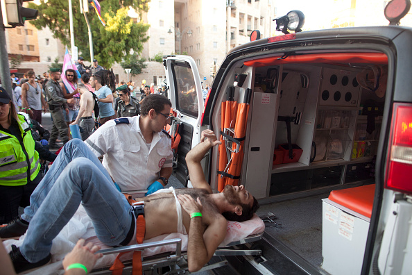 JERUSALEM, ISRAEL - JULY 30:  A wounded Israeli person receives treatment during the gay parade on July 30, 2015 in Jerusalem, Israel. At least six people were stabbed at Jerusalem's annual Gay Pride Parade on Thursday. The assailant, an ultra-Orthodox Jew, emerged behind the marchers and began stabbing them while screaming. A police officer then managed to tackle him to the ground and arrest him.  (Photo by Lior Mizrahi/Getty Images)