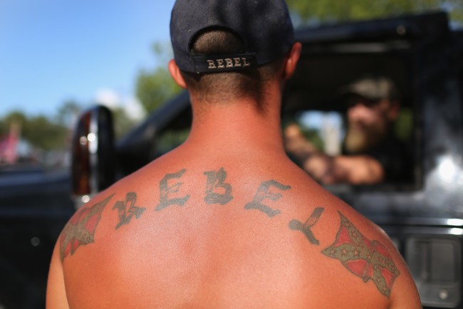 LOXAHATCHEE, FL - JULY 11:  "Rebel"  displays a Confederate flag tattoo as he participates in a rally to show support for the American and Confederate flags on July 11, 2015 in Loxahatchee, Florida. Organizers of the rally said that after the Confederate flag was removed from South Carolinas State House it reinforced their need to show support for the Confederate flag which some feel is under attack.  (Photo by Joe Raedle/Getty Images)