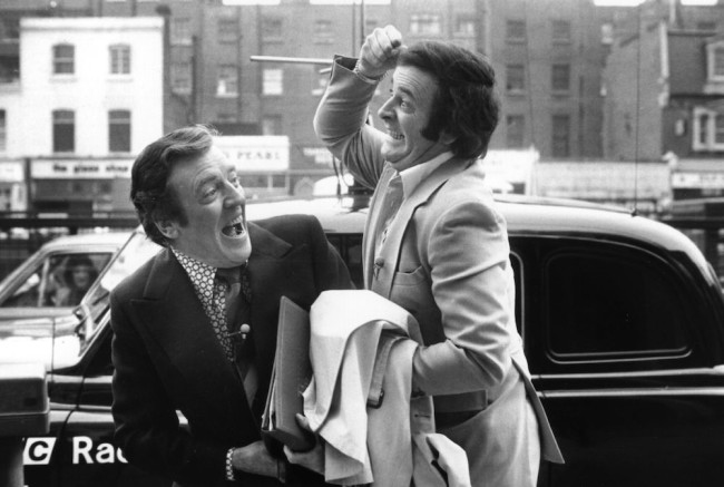Terry Wogan, broadcaster and writer, cavorts with fellow broadcaster Eamonn Andrews (1922 - 1987).   (Photo by Evening Standard/Getty Images)