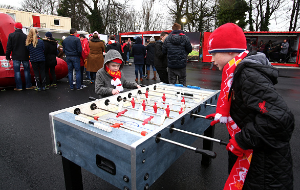 Young Liverpool supporters play at a football table prior to the Barclays Premier League match between Liverpool and Sunderland at Anfield on February 6, 2016 in Liverpool, England.