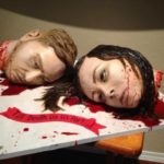 Happy couple serve their decapitated heads as wedding cake