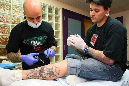 PICTURES here of a man having actual silicon implants added to his tattoo of 